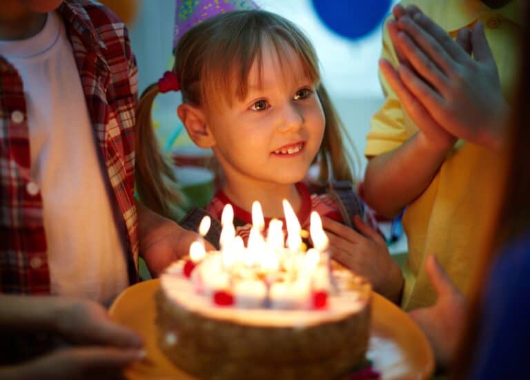 Cute niece celebrating birthday blowing out candles