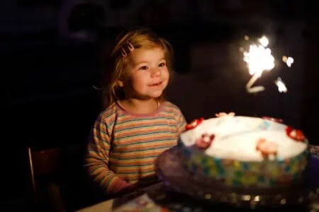Adorable toddler celebrating third birthday