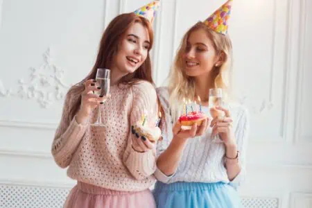 Two girls wearing party hats celebrating sister-in-law birthday